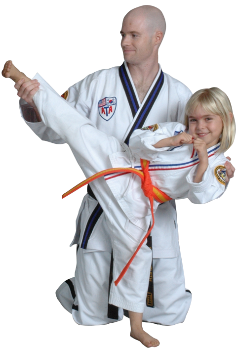 instructor teaching young girl how to kick